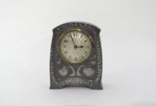 Liberty & Co Tudric pewter clock, No 01424, with Arabic numerals to the circular dial. Hammered