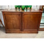 A 19th Century mahogany two door low housekeepers cupboard with reeded top, plinth base, 87cm, 125.