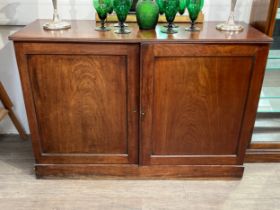 A 19th Century mahogany two door low housekeepers cupboard with reeded top, plinth base, 87cm, 125.