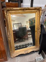 A highly ornate gilt hall mirror, small bits of gesso missing, 117cm x 85cm