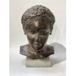 A bust of a boy by Els Van Foeken on marble plinth bust, signed to underside, 37.5cm tall x 23cm