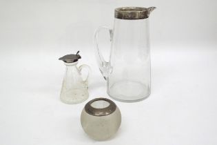 A silver rimmed jug, noggin and match striker (3)