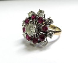 A ruby and diamond cocktail ring, the centre diamond 0.75ct approx surrounded by eight rubies and
