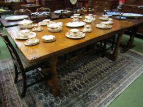 A 17th Century revival pegged oak plank top refectory dining table with cleated ends over cannon