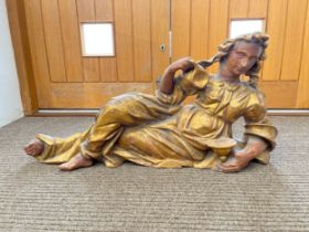 A 19th Century carved giltwood recumbent female figure holding a jug, 97cm x 46cm
