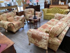 A Classical style three piece suite with inverted melon fluted legs to castors. the sofa is approx