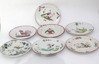Seven 19th Century French Faience plates decorated with Birds and oriental figures, chips and