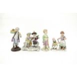 A Sitzendorf figural group and three Naples figures including child feeding chickens and couple with