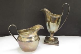 Two George Nathan & Ridley Hayes silver cream jugs, one of helmet form, Chester 1897, 16.5cm tall,