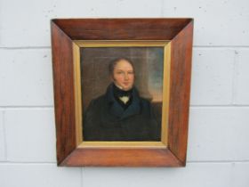 An early 19th Century oil on canvas of a gentleman in a blue jacket. Set in period rosewood frame.