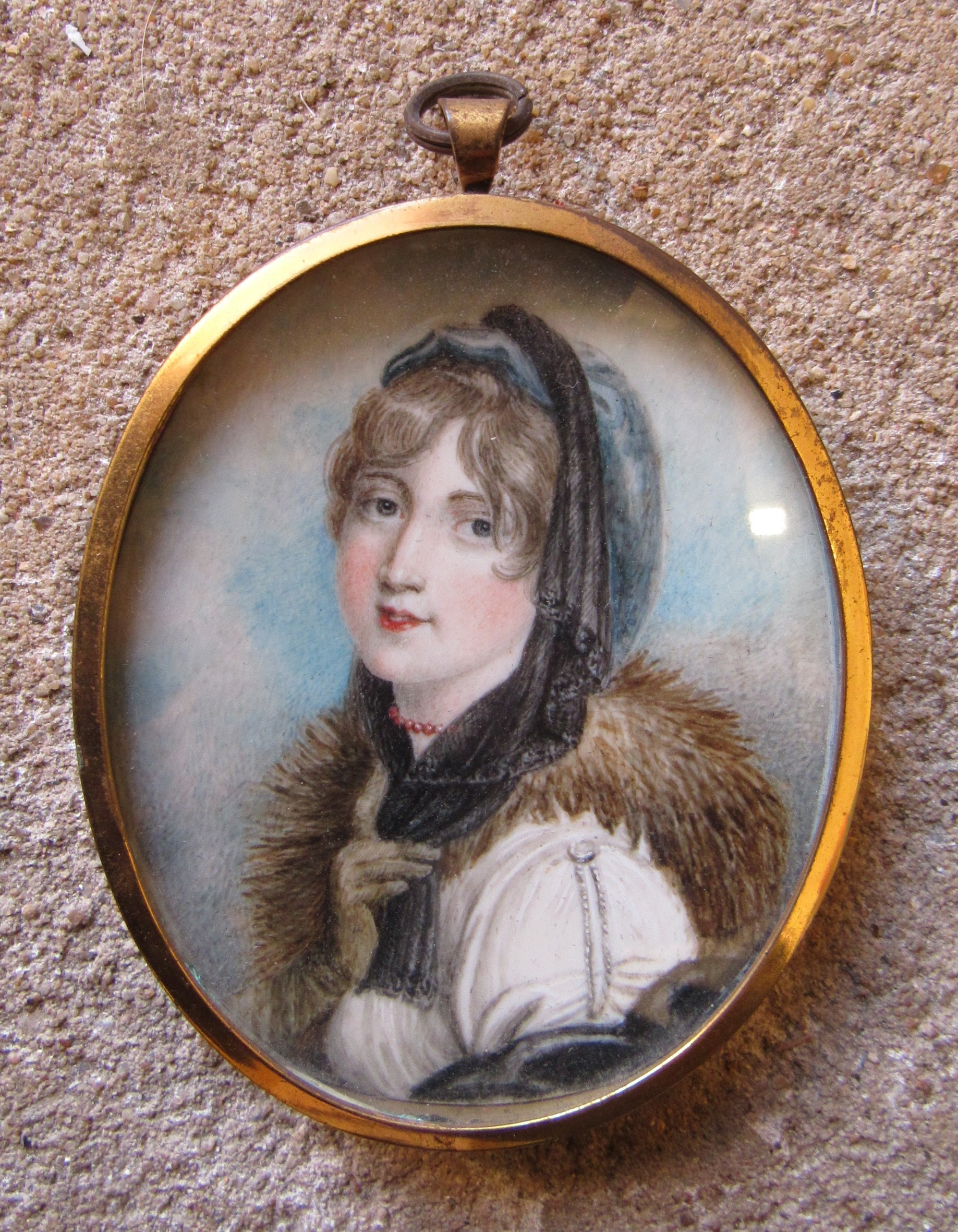 A 19th Century watercolour on oval ivory panel of a young woman with fur collar. Unsigned. Brassed - Image 2 of 4