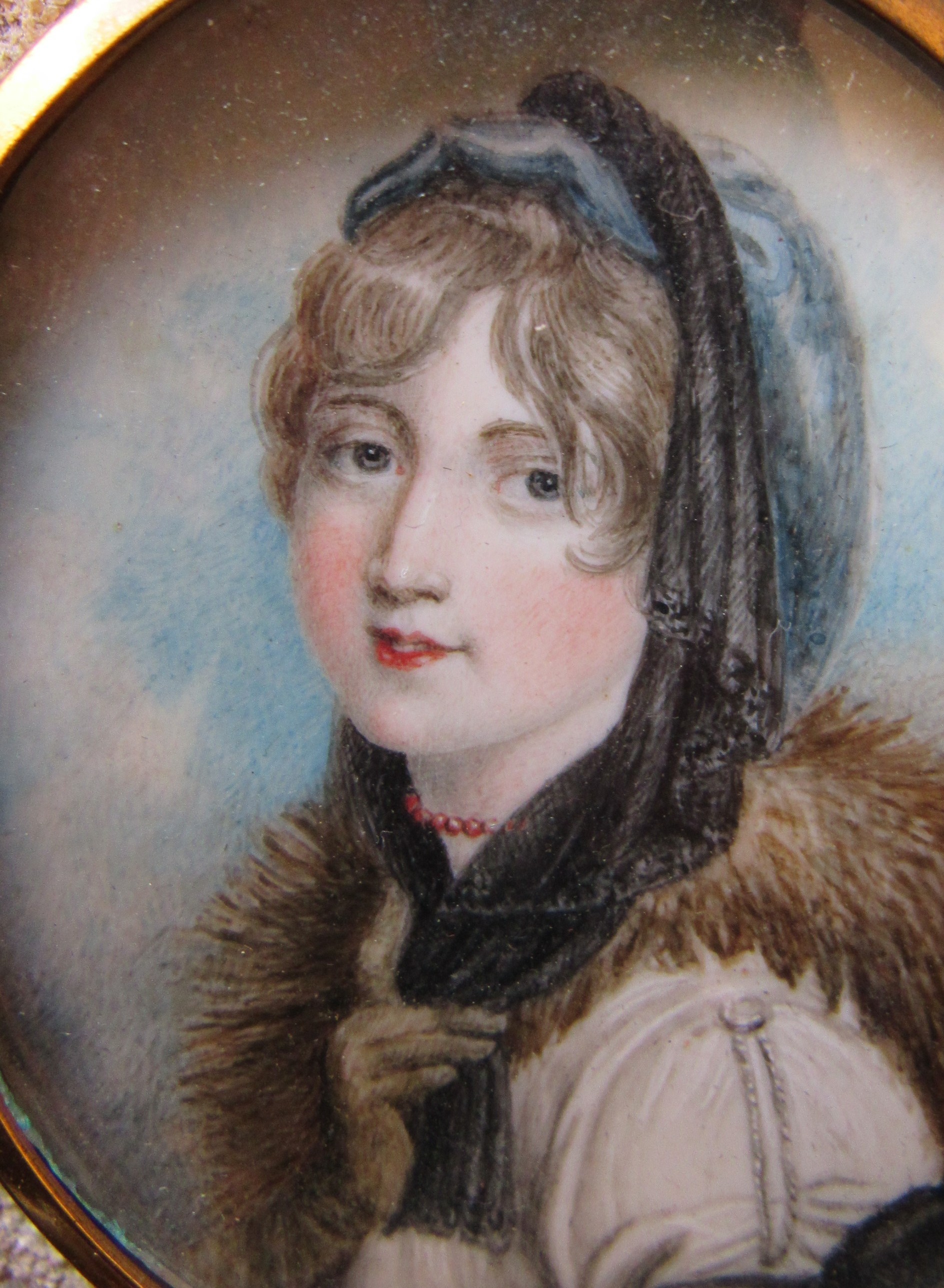 A 19th Century watercolour on oval ivory panel of a young woman with fur collar. Unsigned. Brassed - Image 3 of 4
