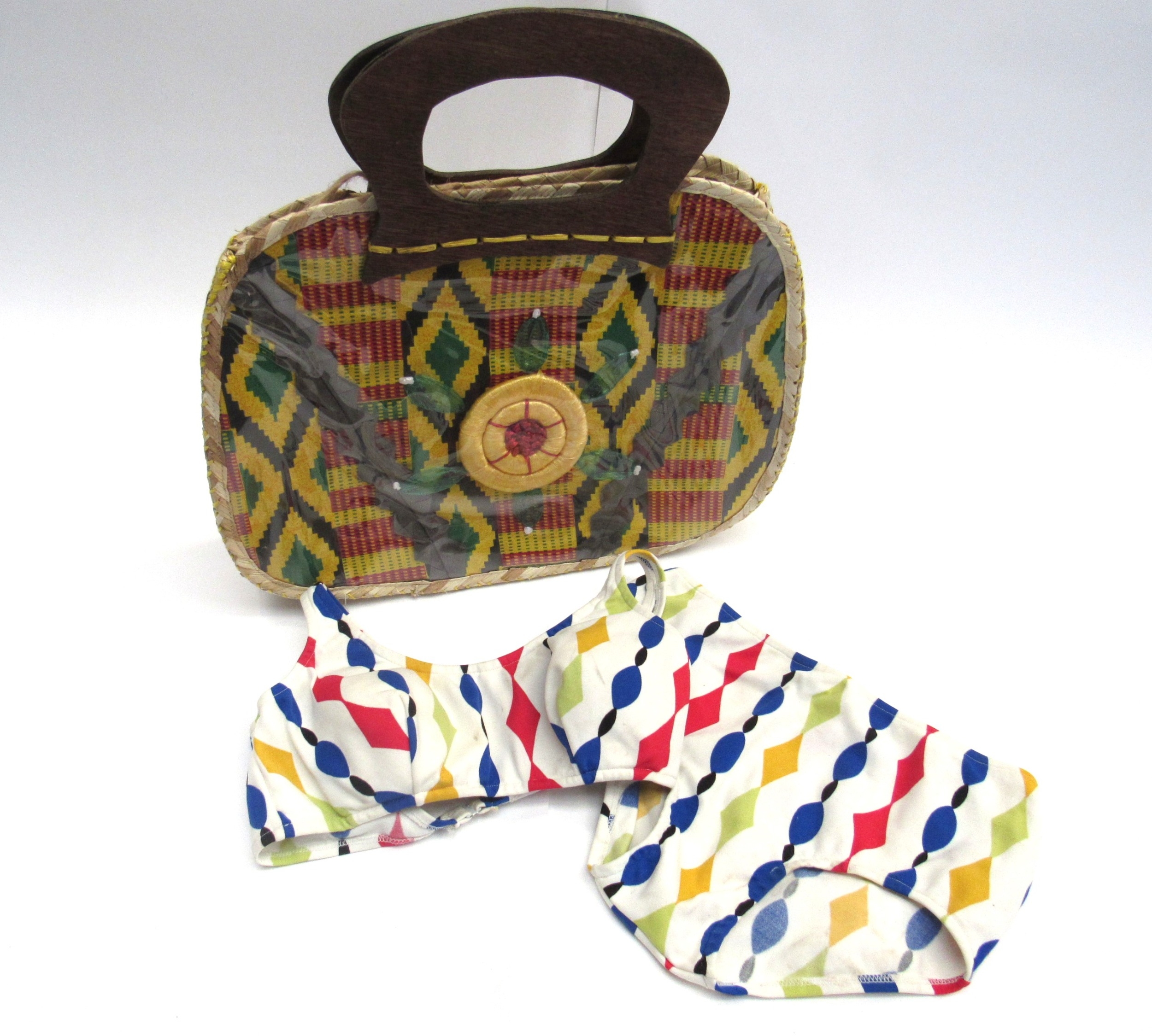 A vintage raffia picnic basket containing mid 20th Century fashion accessories to include a raffia