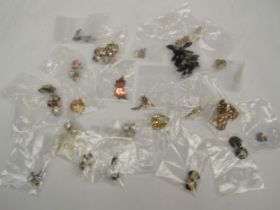 Various pairs of vintage earrings all contained in a 1970's Black Magic box