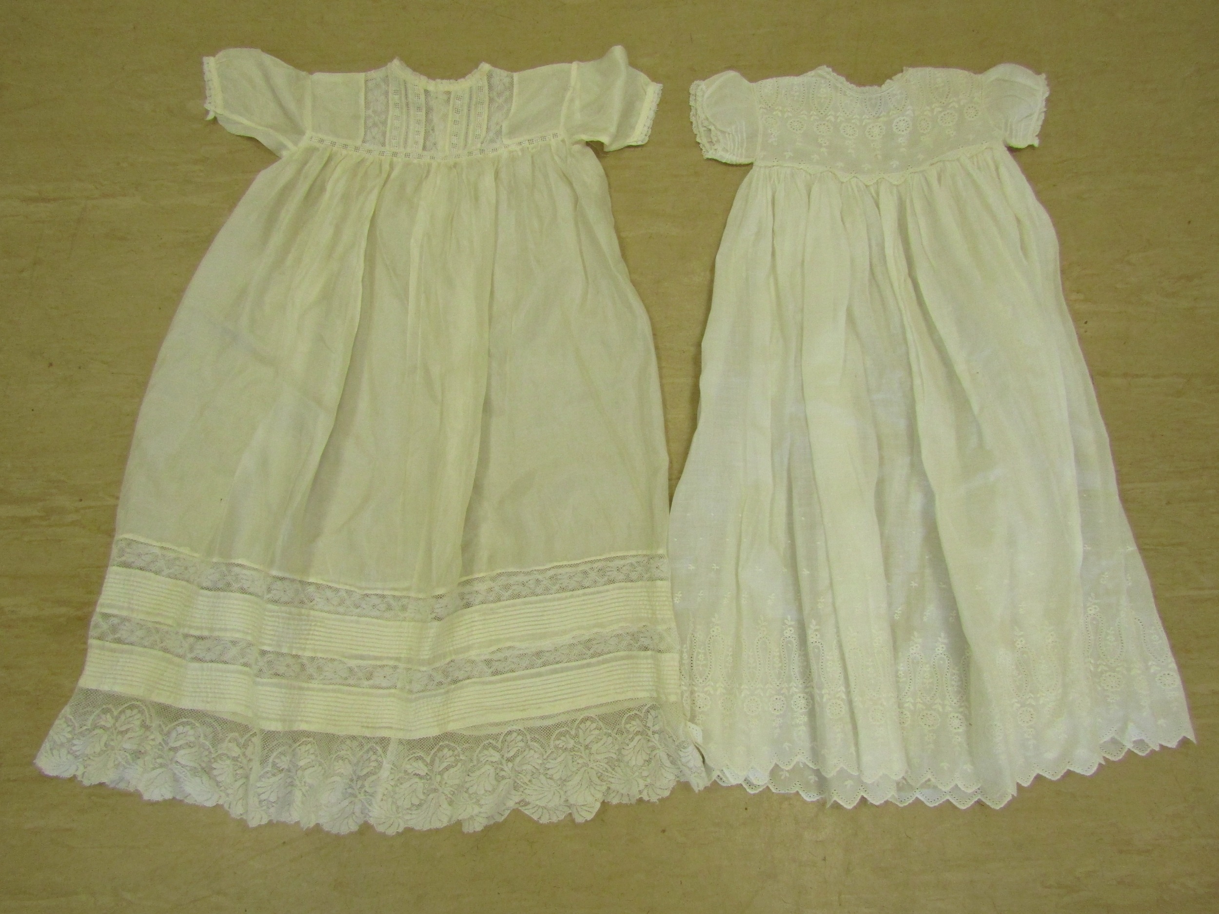 Two pairs of Victorian lace baby shoes and two circa 1900 baby dresses in silk and cotton