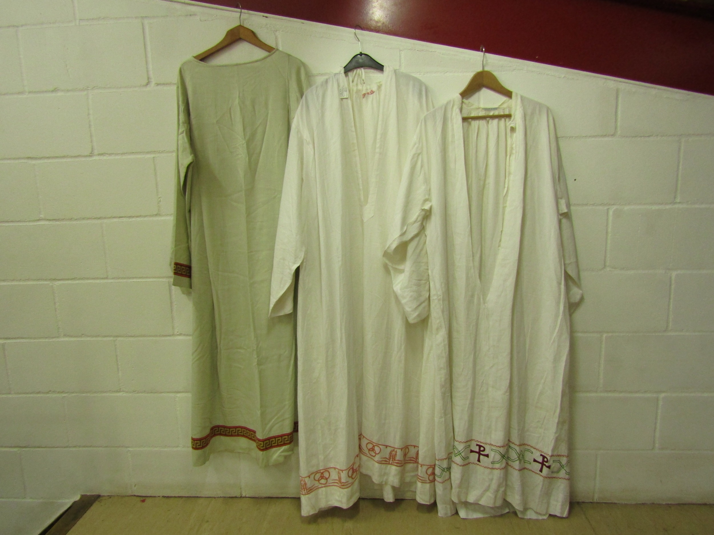 Five white linen and cotton religious surplices, two with bands of Greek key design