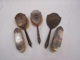 Four vintage silver back dressing table hair brushes and mirror marked Birmingham, monogram "M"