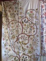 A pair of linen and crewelwork curtains, lined and interlined with a padded border to both