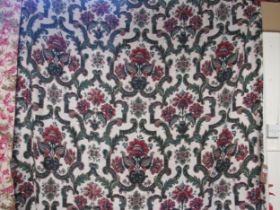 A pair of red and green linen country house curtains with a trailing foliate design