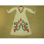 A Middle Eastern cream heavy cotton full length kaftan with emerald and scarlet hand embroidered