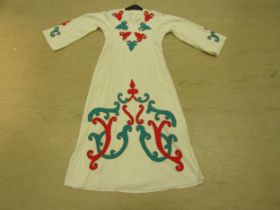 A Middle Eastern cream heavy cotton full length kaftan with emerald and scarlet hand embroidered