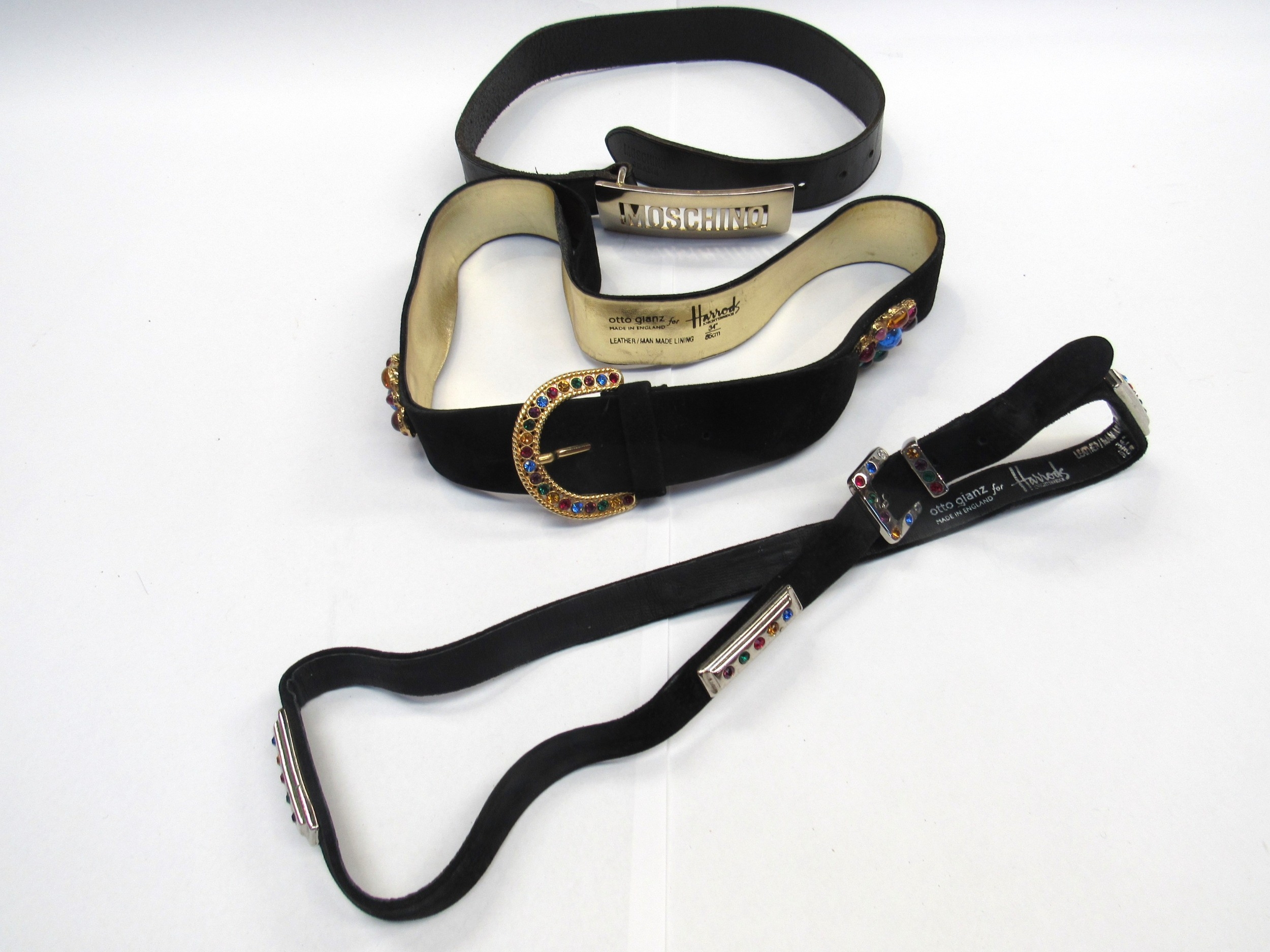Two Otto Glanz fashion belts for Harrods and a Moschino Jeans black belt with a yellow metal buckle