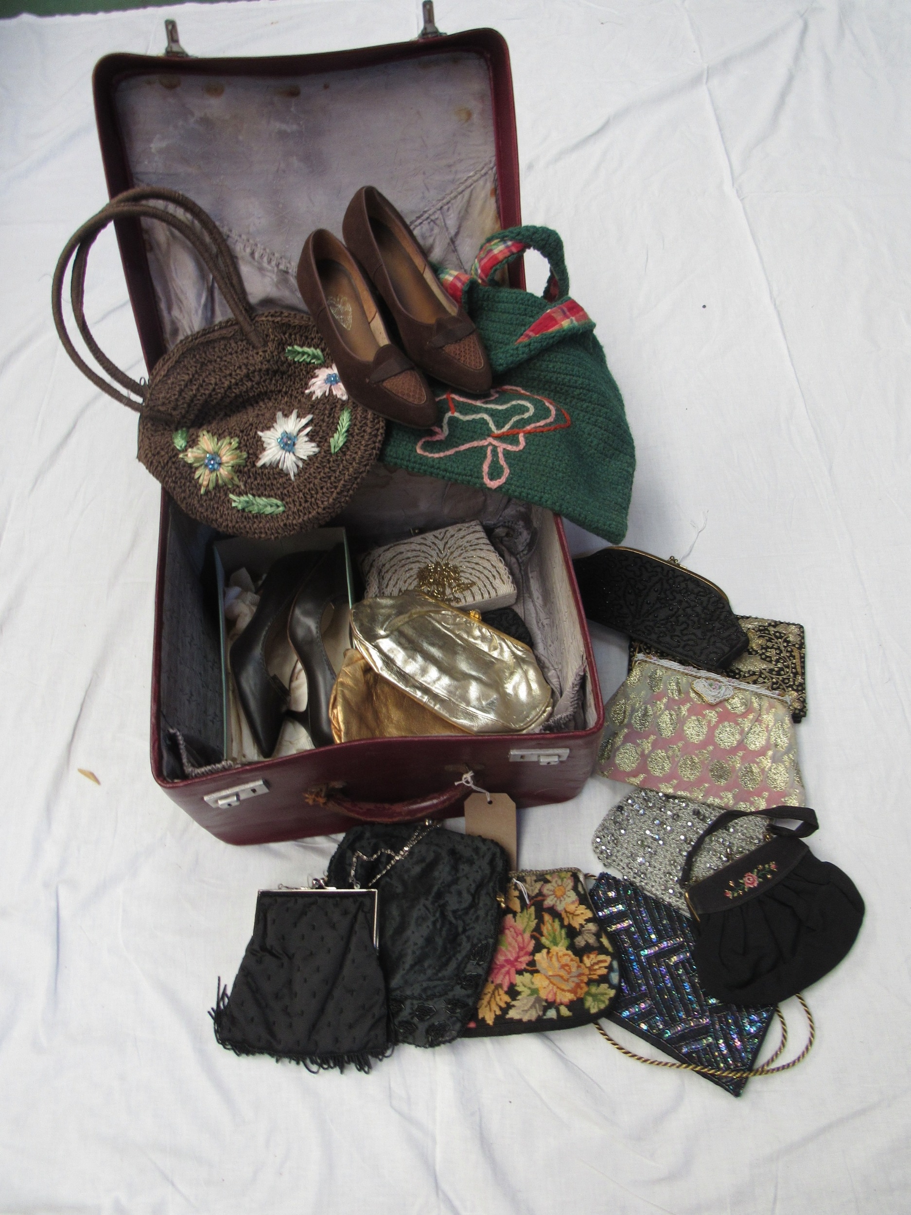 A small burgundy leather traveling case with original travel provenance labels containing mainly