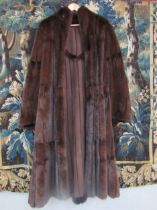 A dark brown Mink and Suede reversible coat, the pelts are of a fabulous quality, the coat is