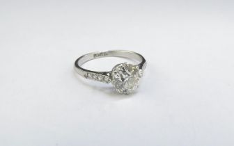 A diamond solitaire ring 1.50ct diamond approx, with diamond set shoulders, platinum shank. Size