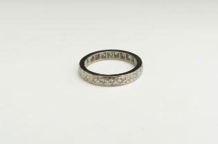 A diamond eternity ring, unmarked white metal shank. Size O, 3.7g