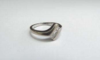 An 18ct white gold ring set with three square diamonds. Size O, 5.4g