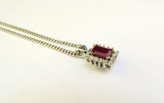 A white gold diamond and ruby pendant, unmarked, 2.1g hung on a 925 chain