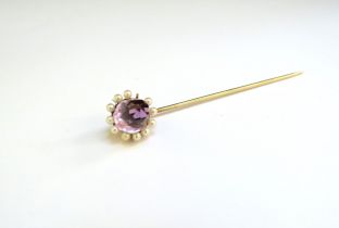 An unmarked gold amethyst and pearl stick pin, one pearl missing, 3.8g