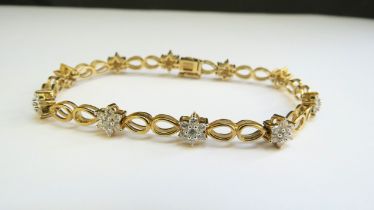 A 9ct gold bracelet with cubic zirconia floral links, 18cm long, 9.3g