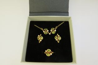 A suite of peridot jewellery consisting of earrings, ring, size Q and necklace, all stamped 750,