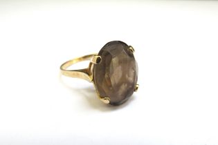 A 9ct gold ring set with an oval smoky quartz. Size N, 3.7g
