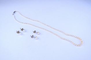 A single strand fine pearl necklace and two pairs of pearl stud earrings