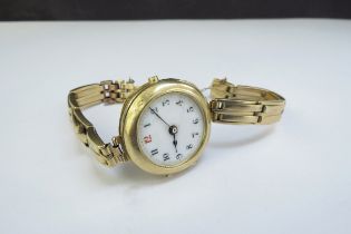 An 18ct gold wristwatch, no glass, dented, 32.5g