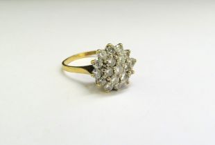 A gold diamond cluster ring, stamped 18ct. Size Q, 5.4g