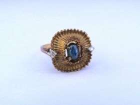 A cabochon sapphire and diamond ring, shank stamped 750. Size P/Q, 5.3g