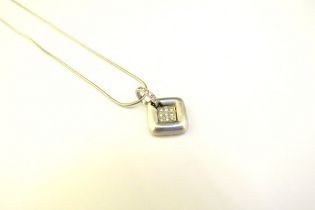An 18ct white gold diamond set pendant of square form hung on chain, 40cm long, 8g