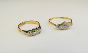 Two 18ct gold diamond rings, one three stone diamond, size J/K, the other an illusion set diamond