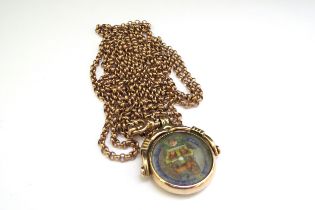 A gold framed enamelled coin swivel fob stamped 10c, hung on metal chain