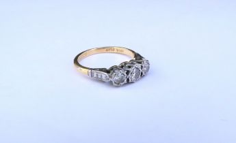 A three stone diamond ring, stamped 18ct/plat. Size J/K, 2.6g