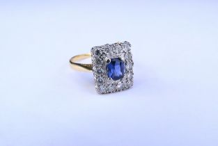 An 18ct gold sapphire and diamond ring, the central oval sapphire framed by fourteen diamonds in