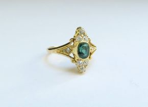 An emerald and diamond ring in marquise shape, stamped 18ct. Size I, 2.8g