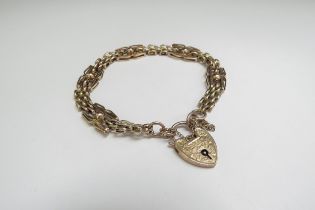 A 9ct gold smooth and textured link bracelet with padlock clasp, 9g