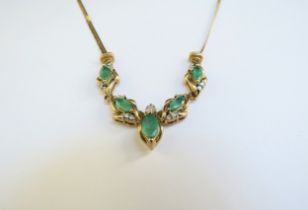 A 9ct gold emerald and diamond necklace, the five marquise shape emeralds studded with diamond to