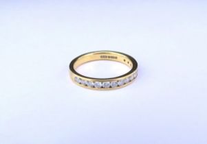 An 18ct gold half hoop diamond ring in channel setting. Size M/N, 3g