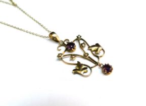 A gold chain stamped 9kt, 40cm long hung with a gold pendant with seed pearl and amethyst coloured